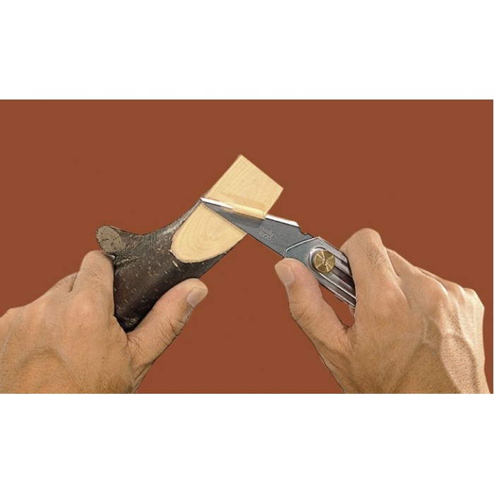 A leatherworker using the Olfa CK-2 knife to cut a piece of leather.